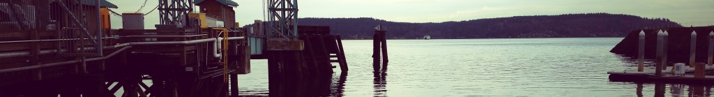 Ferry terminal by the sea with mountains in the background